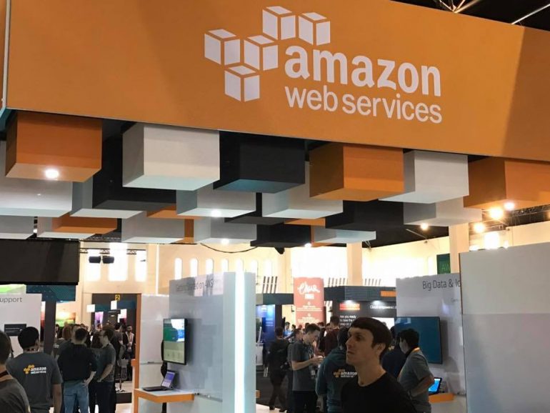 amazon web services sign over an open-plan office