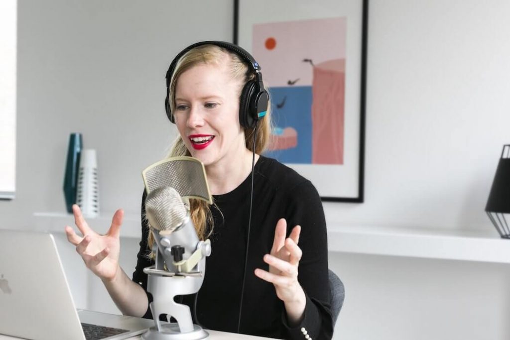 woman-recording-podcast-at-mic (1) | BetaKit
