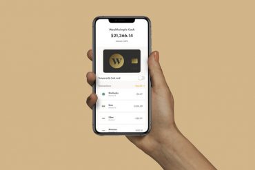 Hand holding phone with Wealthsimple Cash app open