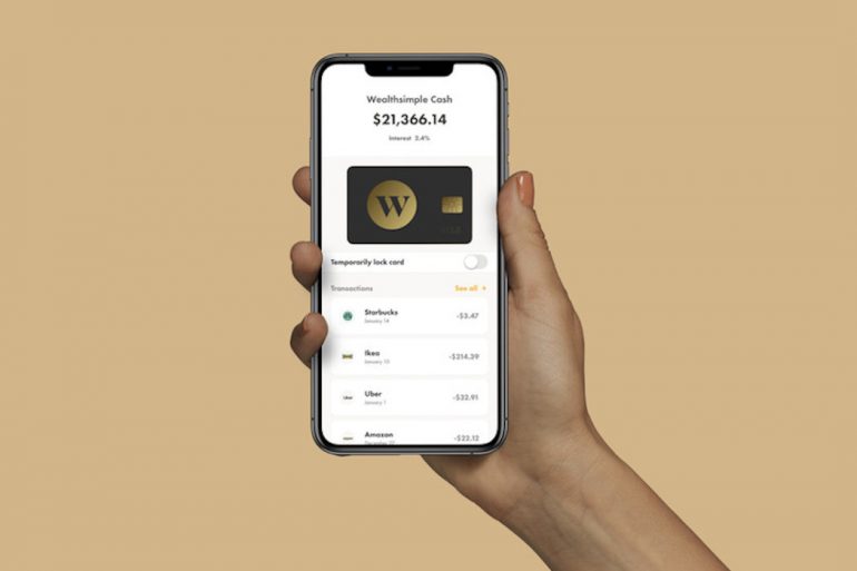 Hand holding phone with Wealthsimple Cash app open