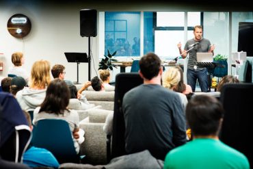 Greg Smith of Thinkific addressing team at Thinkific HQ