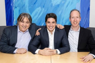 Novisto co-founders seated together, smiling.