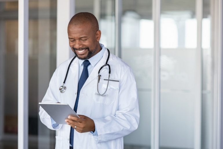 Smiling doctor using Think Research's tech