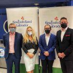 Premier Andrew Furey standing next to Sarah Murphy, Ed Clarke, and Gregory Smyth in front of the Newfoundland and Labrador banner.