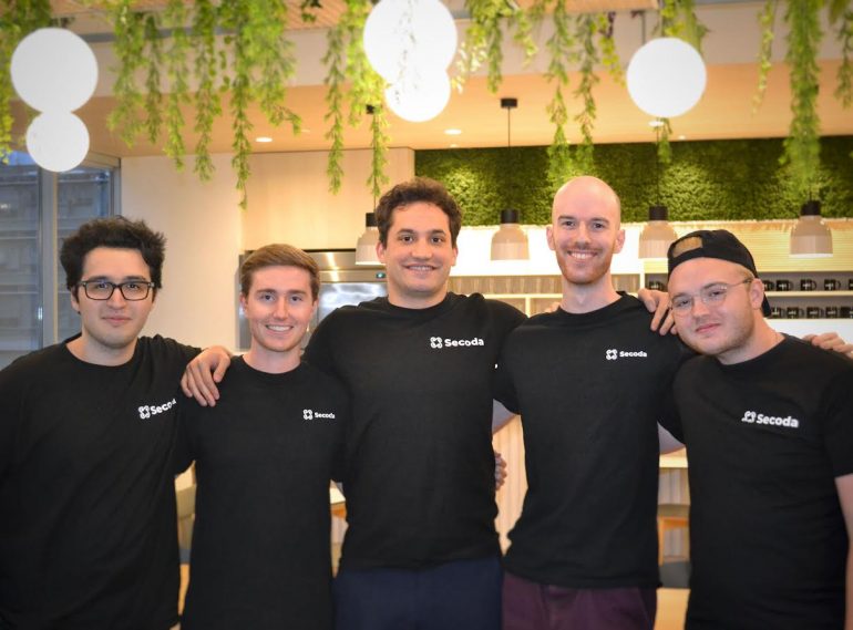 Secoda team in black t-shirts with the Seconda logoposing for a picture