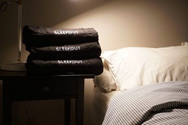 Sleepout curtains on a nightstand by a bed