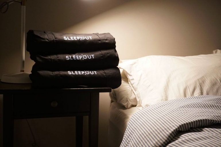 Sleepout curtains on a nightstand by a bed