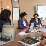 Business women in conference room with laptops