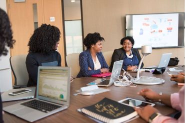 Business women in conference room with laptops