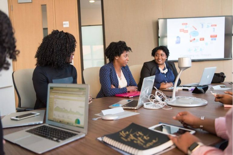 Business women in conference room with laptops