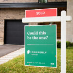 Sold sign in front of a house with properly logo