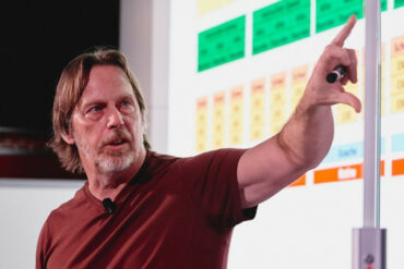 Jim Keller pointing at a graph