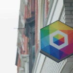 recursion logo on sign outside of brick building