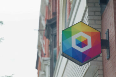 recursion logo on sign outside of brick building