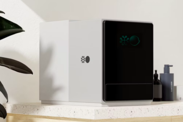 a device for testing blood on a desk. it resembles a desktop computer in shape and size