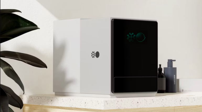 a device for testing blood on a desk. it resembles a desktop computer in shape and size