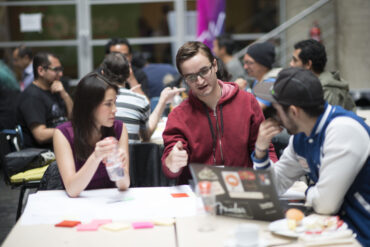 people collaborate over a computer at a Global Partnership event for Techstars