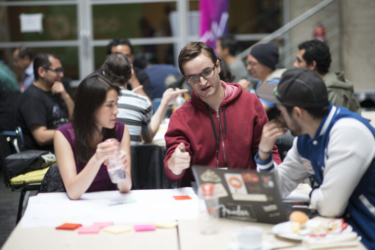 people collaborate over a computer at a Global Partnership event for Techstars