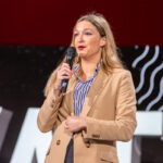 Kara LeBlanc on the podium speaking at Elevate