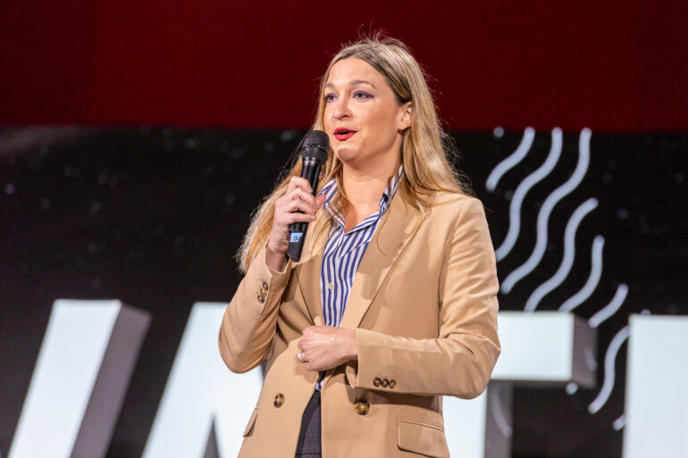 Kara LeBlanc on the podium speaking at Elevate