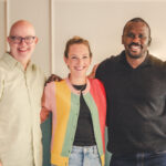 three founders of spring activator pose for a portraits, smiling with their arms around each other