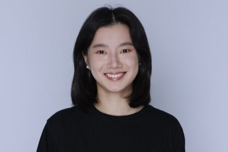 Amy Ding centered in the frame, smiling