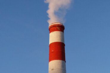 a solitary smoke stack on a blue sky