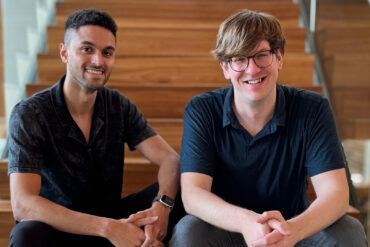 Two men sitting on staircase