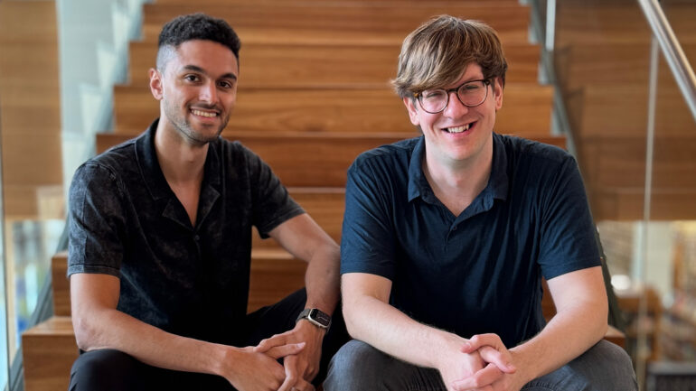 Two men sitting on staircase
