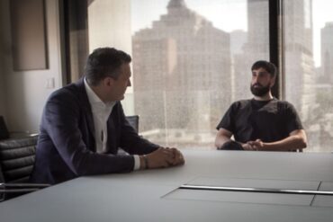Canadian AI Minister Evan Solomon sitting with Cohere CEO Aidan Gomez.