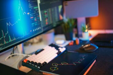 computer with mood lighting showing stock market data