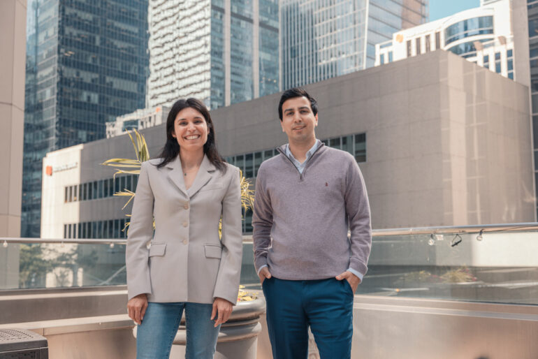 Catherine Ouellet-Dupuis and Sanjay Zimmermann stand together, smiling at the camera
