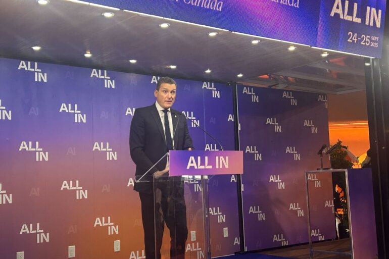 Evan Solomon on stage at ALL IN