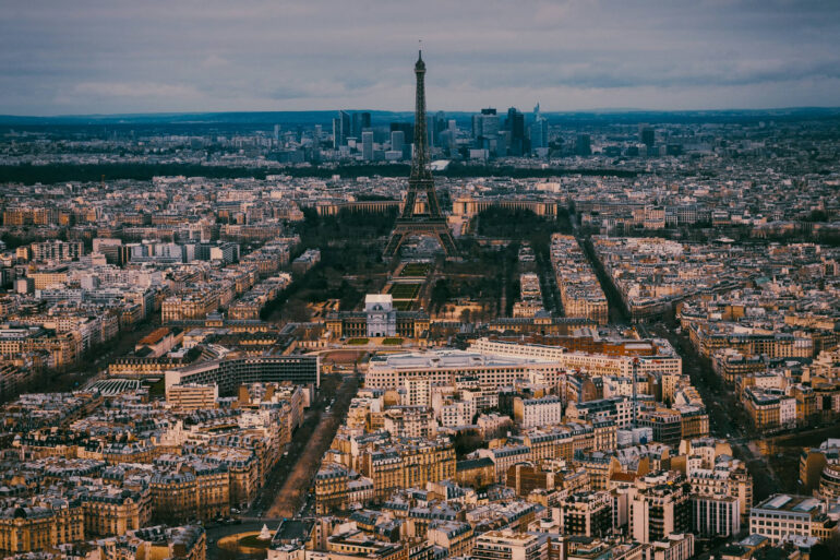 A birds-eye view of Paris, prominently featuring the Eiffel Tower.