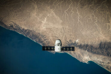 A Satellite hovering above a body of water