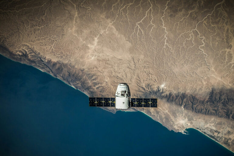 A Satellite hovering above a body of water