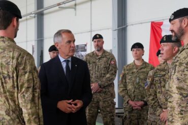 Prime Minister Mark Carney speaks with members of the Canadian Armed Forces.