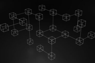A black and white illustration of several cubes connected by lines.