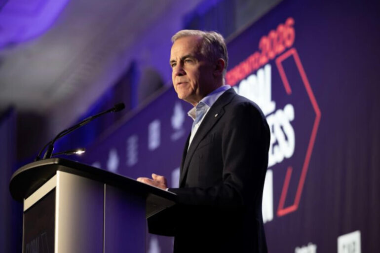 Mark Carney stands at a podium