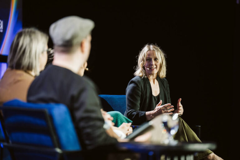 Emily Walsh on stage at ALL IN Talks