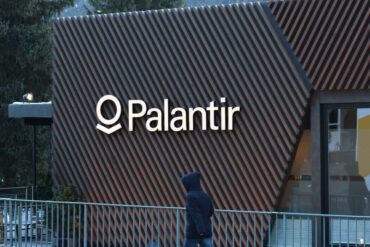 The facade of a building with a Palantir logo on it.